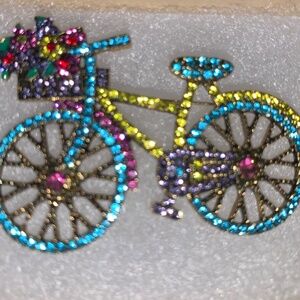 Sparkling bicycle brooch with a basket of flowers